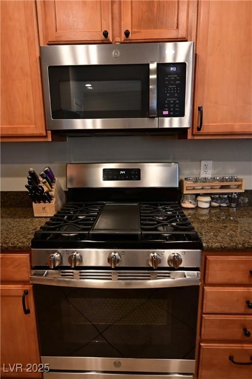 7727 Widewing Dr, North Las Vegas, NV 89084 - kitchen featuring stainless steel appliances and dark stone countertops