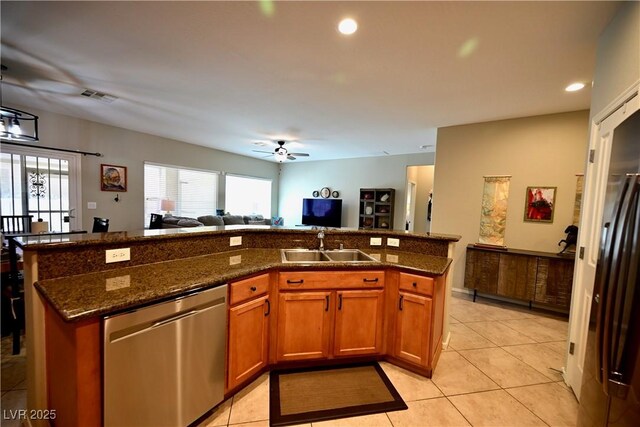 7727 Widewing Dr, North Las Vegas, NV 89084 - kitchen with stainless steel dishwasher, open floor plan, ceiling fan, a sink, and dark stone countertops