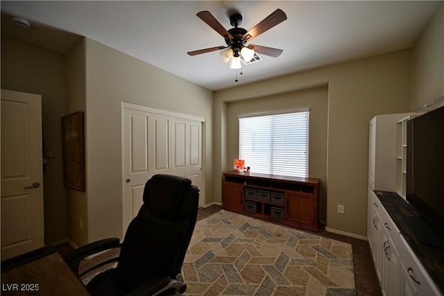 7727 Widewing Dr, North Las Vegas, NV 89084 - home office with ceiling fan, baseboards, and light colored carpet