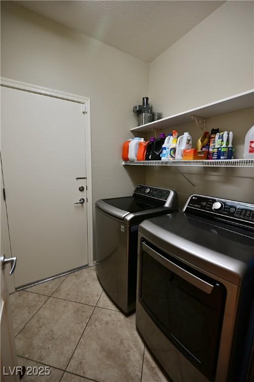 7727 Widewing Dr, North Las Vegas, NV 89084 - laundry area with independent washer and dryer and light tile patterned floors