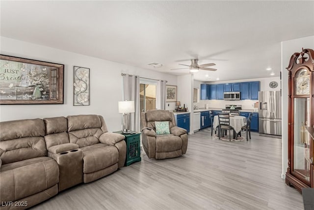 4249 Fleet Dancer St, Las Vegas, NV 89129 - living room with light wood finished floors, ceiling fan, and recessed lighting