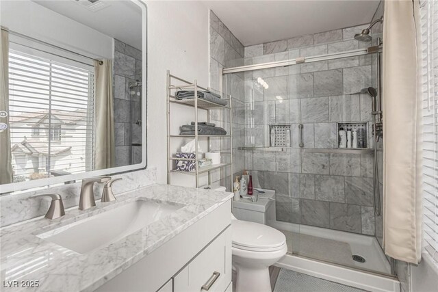 4249 Fleet Dancer St, Las Vegas, NV 89129 - bathroom featuring a stall shower, toilet, and vanity