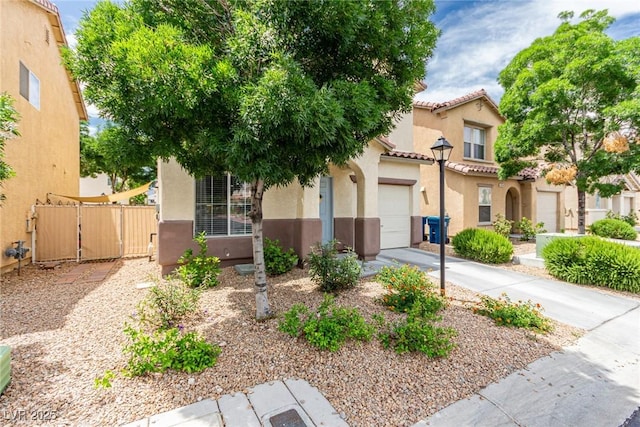 4249 Fleet Dancer St, Las Vegas, NV 89129 - view of front of property featuring stucco siding, a tiled roof, concrete driveway, an attached garage, and a gate
