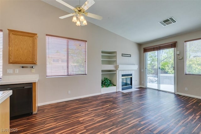 3336 Hidden Ridge St, Las Vegas, NV 89129 - unfurnished living room with dark wood-type flooring, built in shelves, baseboards, ceiling fan, and high vaulted ceiling