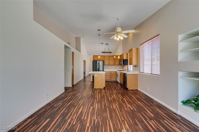 3336 Hidden Ridge St, Las Vegas, NV 89129 - kitchen with appliances with stainless steel finishes, light countertops, dark wood-style flooring, a kitchen island, and baseboards