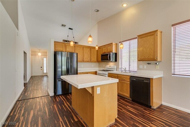 3336 Hidden Ridge St, Las Vegas, NV 89129 - kitchen with stainless steel appliances, high vaulted ceiling, a kitchen island, dark wood finished floors, and baseboards