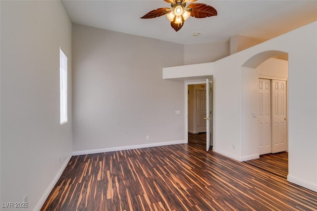 3336 Hidden Ridge St, Las Vegas, NV 89129 - unfurnished room with wood finished floors, a ceiling fan, arched walkways, and baseboards