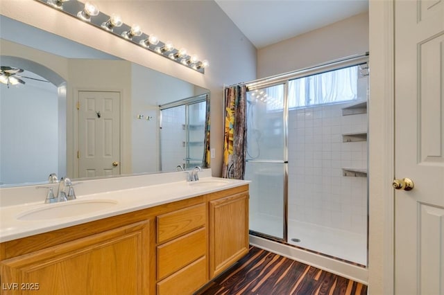 3336 Hidden Ridge St, Las Vegas, NV 89129 - bathroom with a tile shower, double vanity, wood finished floors, and ceiling fan