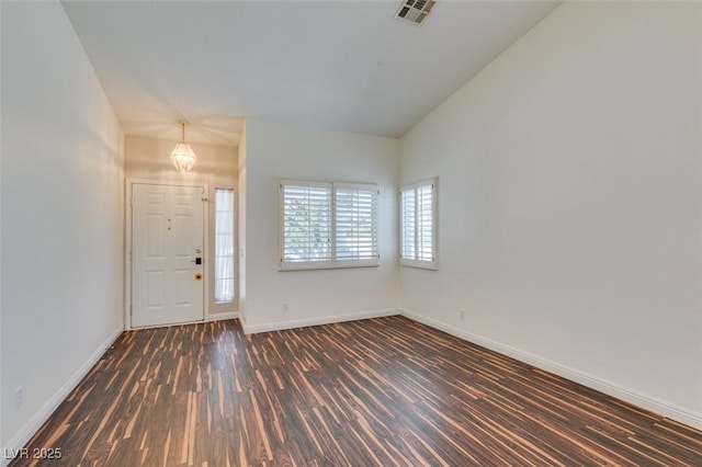 3336 Hidden Ridge St, Las Vegas, NV 89129 - foyer featuring dark wood-style flooring, baseboards, lofted ceiling, and a chandelier