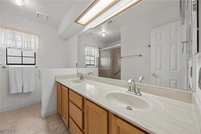 5020 Linkside Dr, Las Vegas, NV 89130 - full bath with double vanity, a shower stall, tile patterned floors, and baseboards