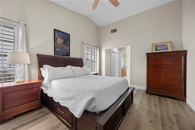 5020 Linkside Dr, Las Vegas, NV 89130 - bedroom with lofted ceiling, light wood-style floors, baseboards, ceiling fan, and ensuite bathroom