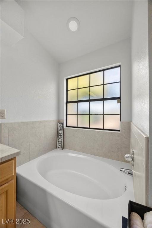 5020 Linkside Dr, Las Vegas, NV 89130 - bathroom with healthy amount of natural light, vanity, and a bath