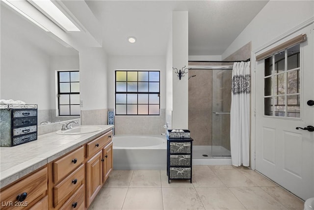 5020 Linkside Dr, Las Vegas, NV 89130 - full bathroom featuring a shower stall, vanity, a garden tub, and tile patterned flooring