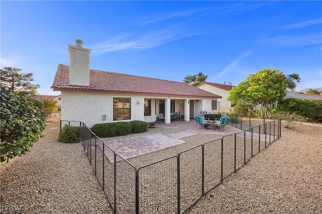 5020 Linkside Dr, Las Vegas, NV 89130 - rear view of property with a tiled roof, stucco siding, a chimney, and a patio area