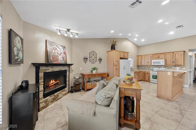 5020 Linkside Dr, Las Vegas, NV 89130 - living area featuring a stone fireplace, lofted ceiling, light tile patterned flooring, and recessed lighting