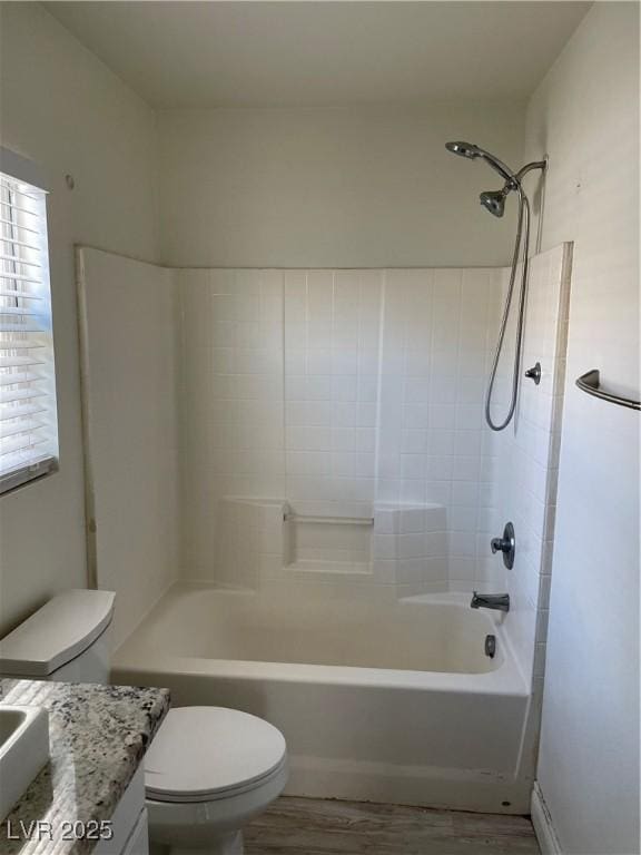 5280 Shreve Ave, Las Vegas, NV 89156 - bathroom featuring toilet, vanity,  shower combination, and wood finished floors