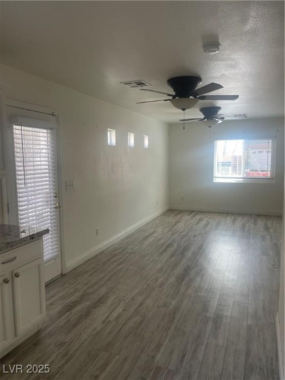 5280 Shreve Ave, Las Vegas, NV 89156 - spare room featuring a ceiling fan, wood finished floors, and baseboards