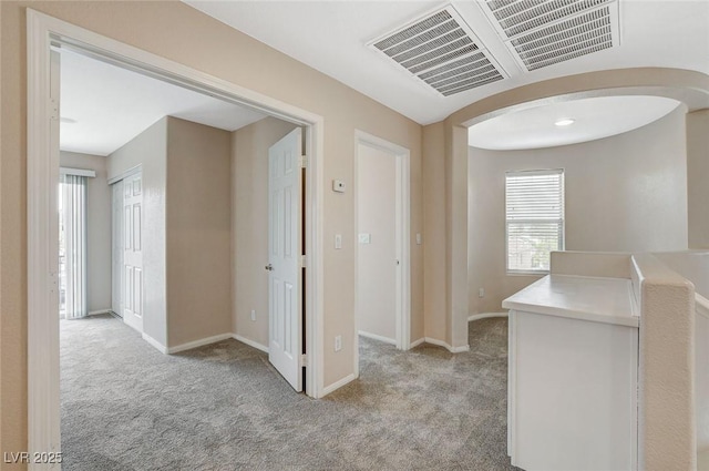 8307 Fort Hallock Ave, Las Vegas, NV 89131 - hallway with light colored carpet, baseboards, and arched walkways