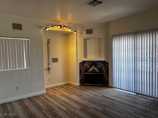 4730 E Craig Rd Unit 1148, Las Vegas, NV 89115 - unfurnished living room featuring wood finished floors, ornamental molding, baseboards, and a high end fireplace