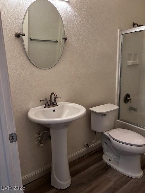 4730 E Craig Rd Unit 1148, Las Vegas, NV 89115 - full bathroom with wood finished floors, baseboards, and combined bath / shower with glass door