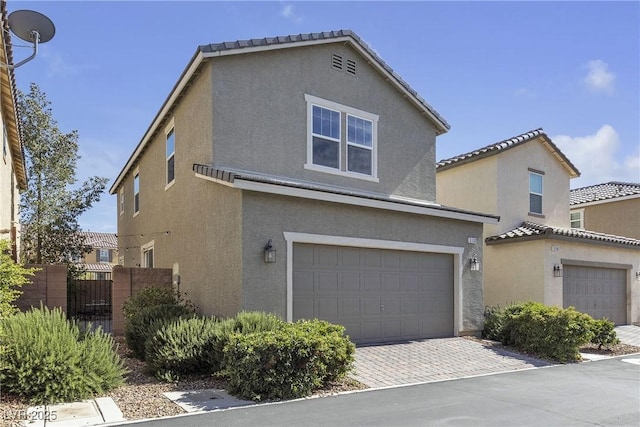 3132 Cartanda Ave, Henderson, NV 89044 - view of front of property featuring a garage, stucco siding, and decorative driveway