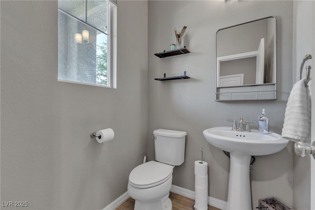 3132 Cartanda Ave, Henderson, NV 89044 - half bath featuring toilet, baseboards, and wood finished floors