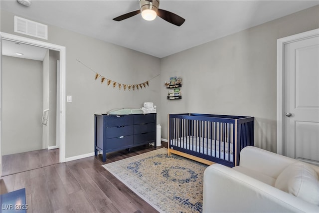 3132 Cartanda Ave, Henderson, NV 89044 - bedroom featuring wood finished floors, baseboards, a ceiling fan, and a nursery area