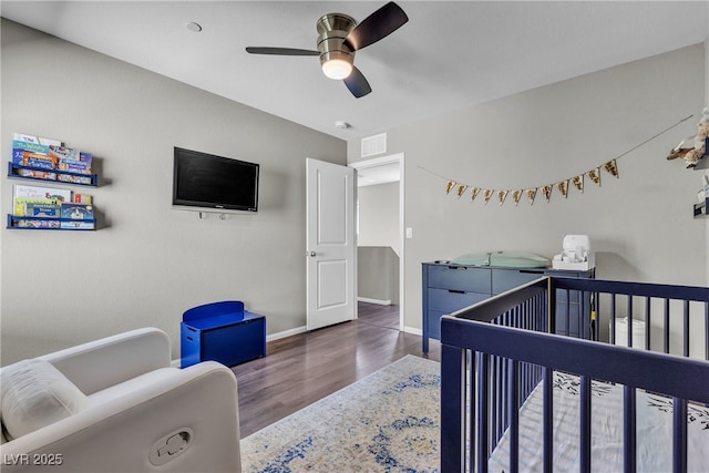 3132 Cartanda Ave, Henderson, NV 89044 - bedroom with wood finished floors, baseboards, a crib, and ceiling fan