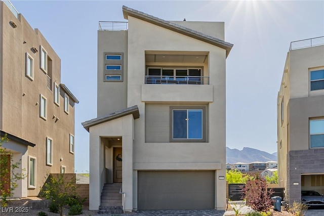 2151 Noble Perch St, Las Vegas, NV 89138 - view of front of house featuring an attached garage, stucco siding, a mountain view, and driveway