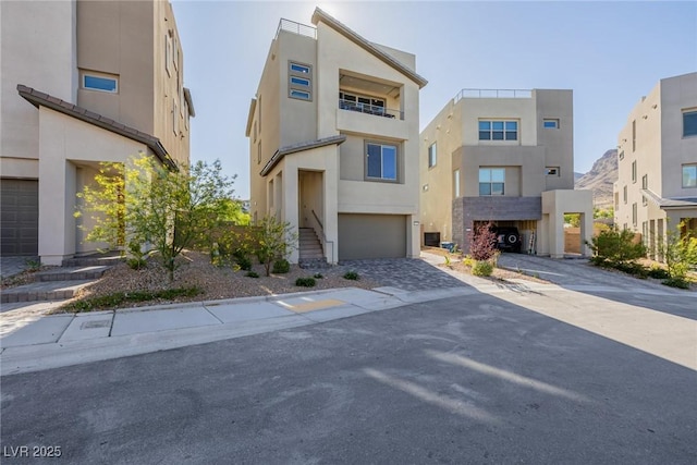 2151 Noble Perch St, Las Vegas, NV 89138 - view of front of property featuring stucco siding, an attached garage, and driveway