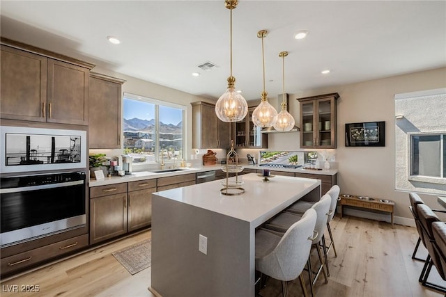 2151 Noble Perch St, Las Vegas, NV 89138 - kitchen featuring stainless steel appliances, light wood-type flooring, a breakfast bar area, light countertops, and recessed lighting