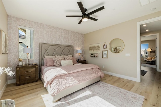 2151 Noble Perch St, Las Vegas, NV 89138 - bedroom featuring wallpapered walls, light wood finished floors, an accent wall, and a ceiling fan