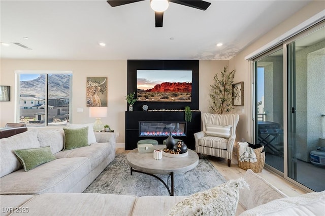 2151 Noble Perch St, Las Vegas, NV 89138 - living area with light wood-style flooring, recessed lighting, a ceiling fan, and a glass covered fireplace