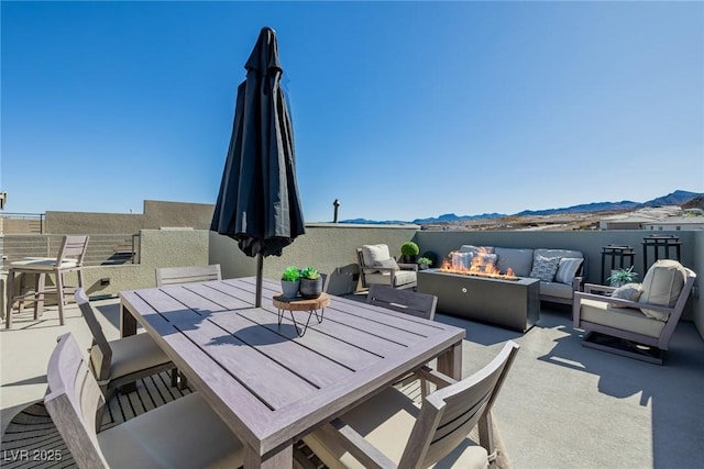 2151 Noble Perch St, Las Vegas, NV 89138 - view of patio with outdoor dining area, an outdoor living space with a fire pit, and a mountain view