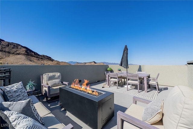 2151 Noble Perch St, Las Vegas, NV 89138 - view of patio with an outdoor living space with a fire pit, a mountain view, and outdoor dining space