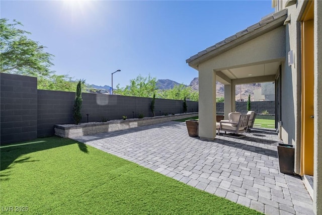 2151 Noble Perch St, Las Vegas, NV 89138 - fenced backyard with a patio area and a mountain view