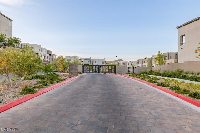 2151 Noble Perch St, Las Vegas, NV 89138 - view of decorative road with a residential view, curbs, a gate, and a gated entry