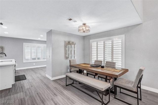 8316 Maplestar Rd, Las Vegas, NV 89128 - dining space featuring baseboards, a chandelier, wood finished floors, and recessed lighting