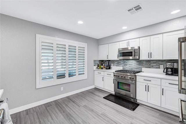 8316 Maplestar Rd, Las Vegas, NV 89128 - kitchen featuring appliances with stainless steel finishes, light countertops, backsplash, light wood-style floors, and recessed lighting