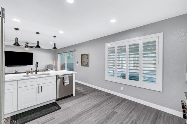 8316 Maplestar Rd, Las Vegas, NV 89128 - kitchen featuring dishwasher, a sink, open floor plan, light wood finished floors, and recessed lighting