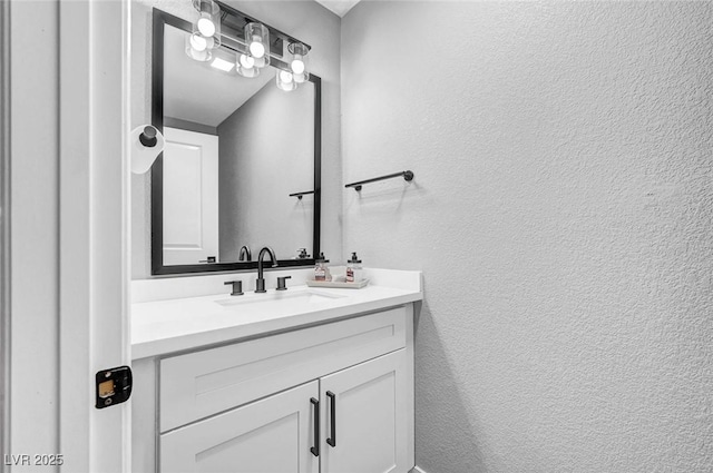 8316 Maplestar Rd, Las Vegas, NV 89128 - bathroom with a textured wall and vanity