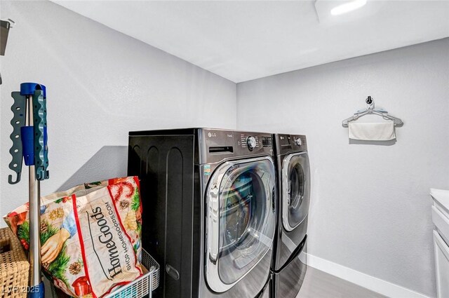 8316 Maplestar Rd, Las Vegas, NV 89128 - laundry area featuring washer and clothes dryer, baseboards, and wood finished floors