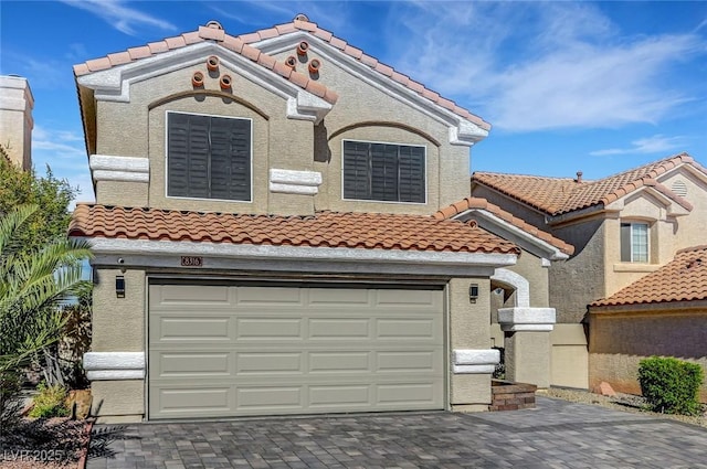 8316 Maplestar Rd, Las Vegas, NV 89128 - mediterranean / spanish-style house featuring a tiled roof, decorative driveway, a garage, and stucco siding