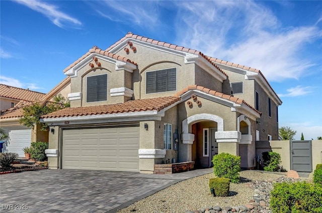 8316 Maplestar Rd, Las Vegas, NV 89128 - mediterranean / spanish home with a tile roof, decorative driveway, a garage, and stucco siding