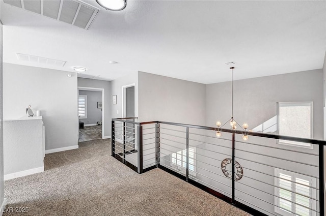 8316 Maplestar Rd, Las Vegas, NV 89128 - corridor with carpet flooring, an upstairs landing, baseboards, and a chandelier