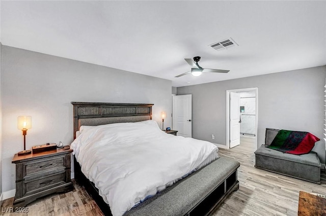 8316 Maplestar Rd, Las Vegas, NV 89128 - bedroom with baseboards, light wood-style flooring, ceiling fan, and ensuite bath