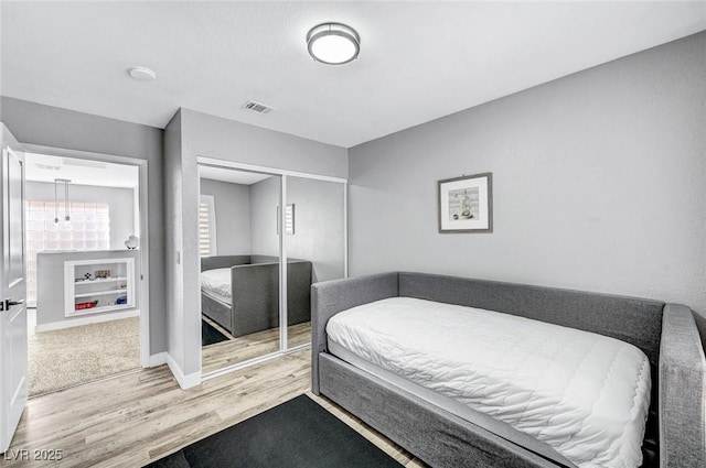 8316 Maplestar Rd, Las Vegas, NV 89128 - bedroom featuring wood finished floors, a closet, and baseboards