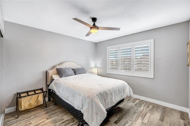 8316 Maplestar Rd, Las Vegas, NV 89128 - bedroom with baseboards, wood finished floors, and ceiling fan
