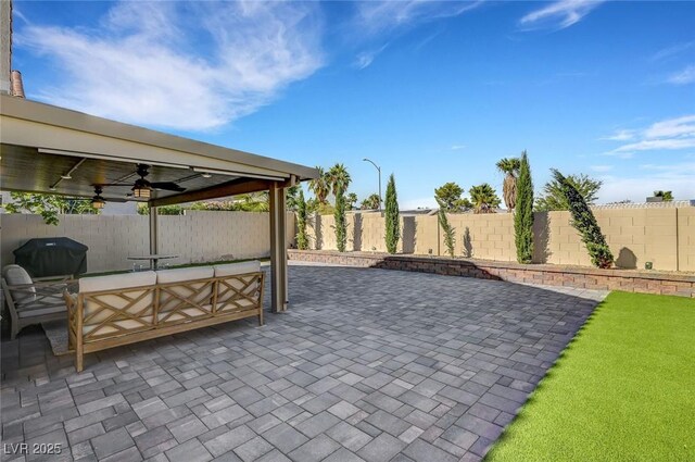 8316 Maplestar Rd, Las Vegas, NV 89128 - fenced backyard with a ceiling fan, a patio area, grilling area, and outdoor lounge area