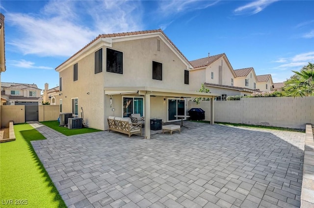 8316 Maplestar Rd, Las Vegas, NV 89128 - back of house with a patio, stucco siding, a fenced backyard, an outdoor living space, and a tiled roof